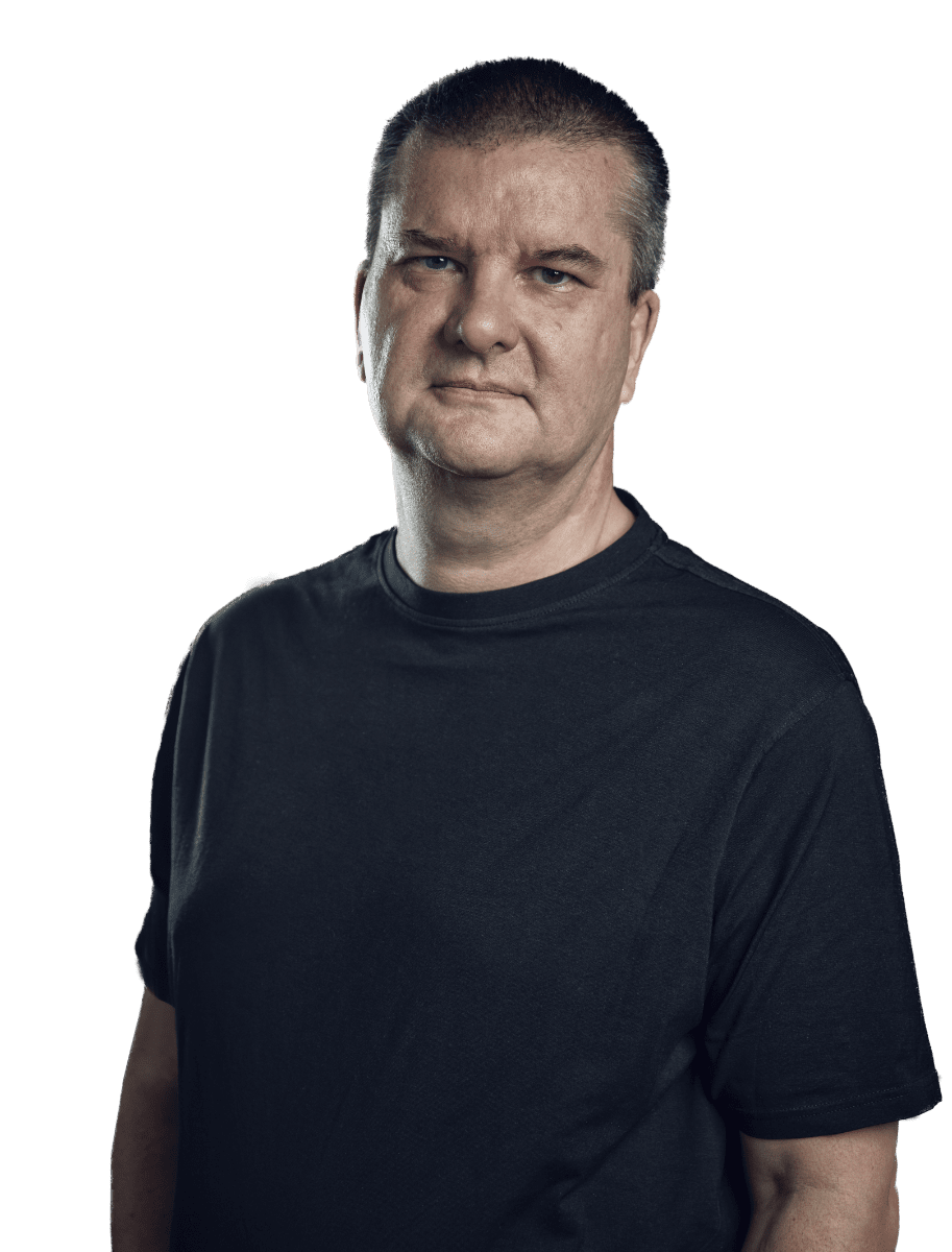 Gordon Sheppard a black shirt standing in front of a green background.